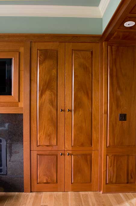 These doors slide back into the cabinets to expose the entertainment equipment. Note the symmetry between door panels.