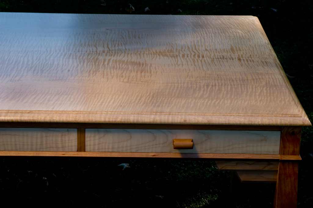 Detail of a curly maple / cherry writing desk. This maple is one of the largest, most figured boards we have ever seen.
