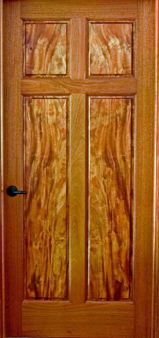 Mahogany bedroom door with matched figured panels.