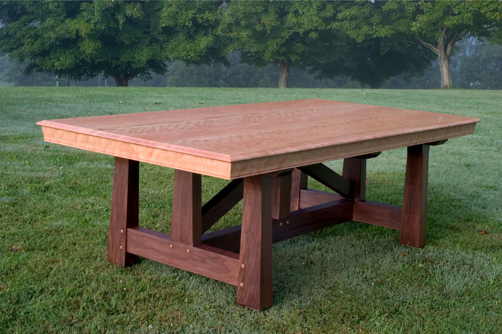 A 4' x 8' cherry and walnut conference table with an old trestle inspired leg system.